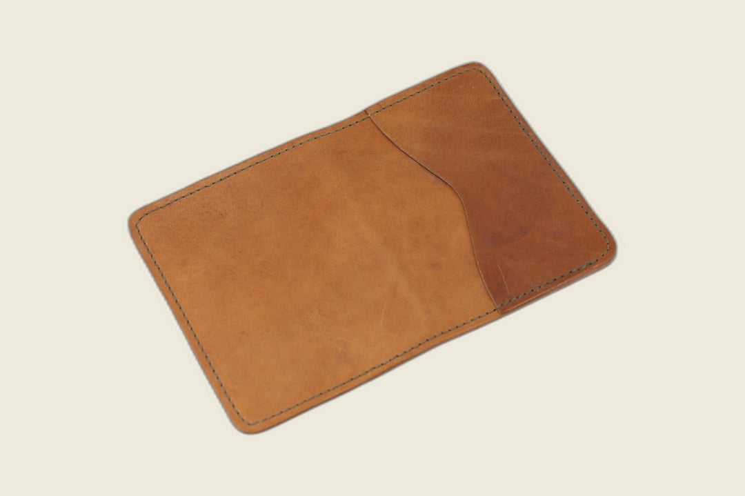Warden bifold wallet in tan Horween 1940s calfskin, opened to show the curved slip pocket
