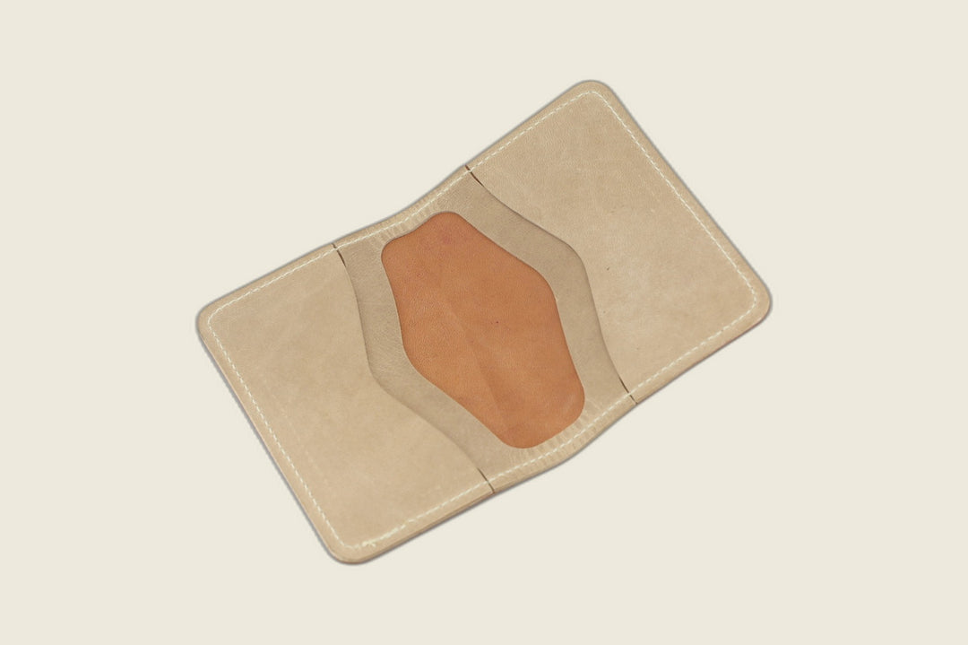 Warden bifold opened to two natural Cypress horsehide card pockets, cream studio backdrop