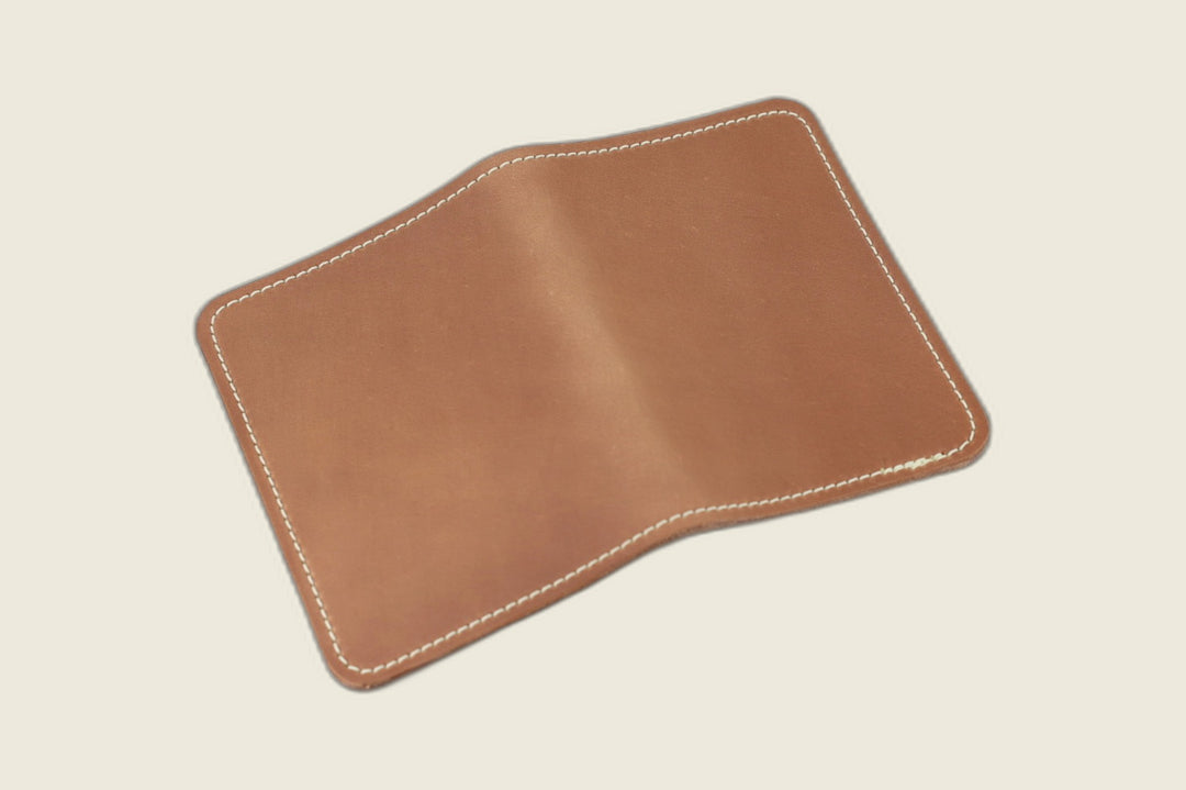 Warden bifold wallet in unglazed natural Horween shell cordovan, matte taupe exterior, cream backdrop