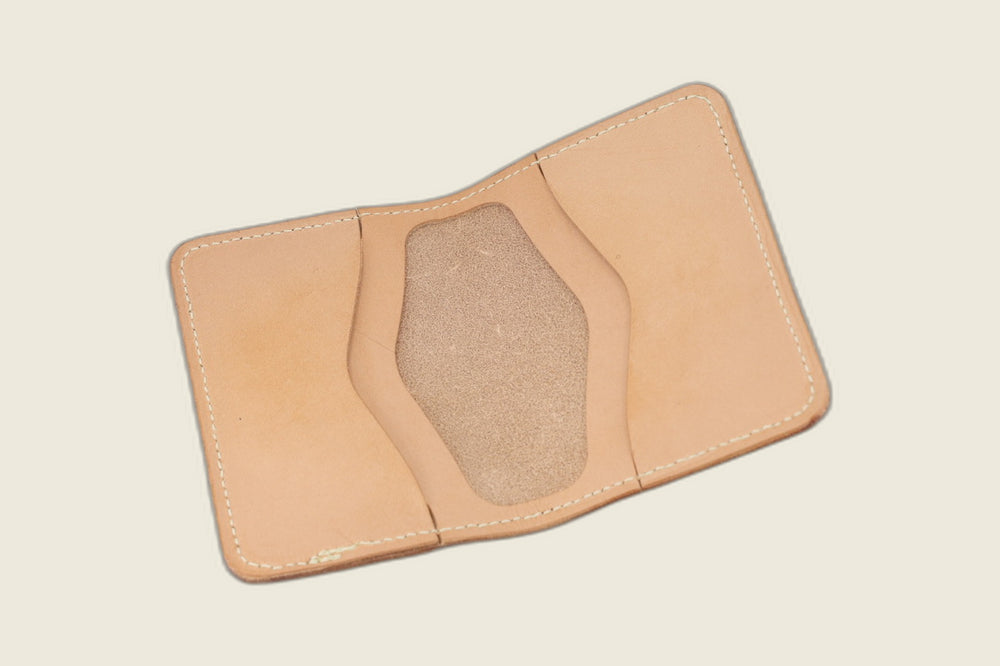 Warden bifold opened to natural veg tan card pockets with roughout suede well