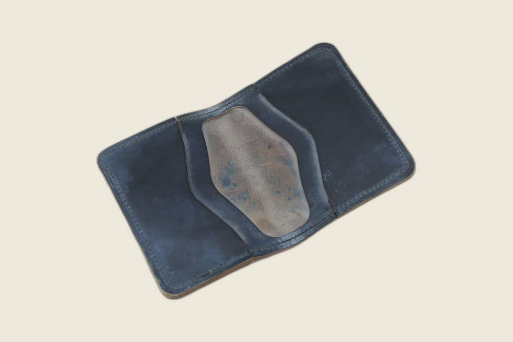 Warden bifold interior with navy Rocado card pockets and mottled blue-brown roughout well