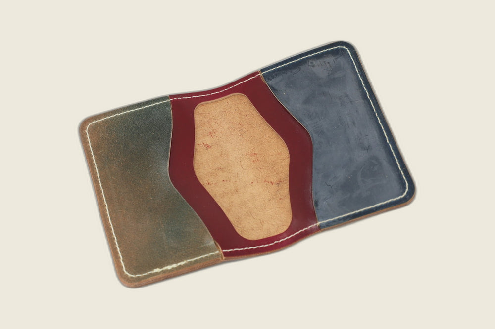 Warden bifold interior with olive, burgundy and navy Rocado shell panels around a tan suede well