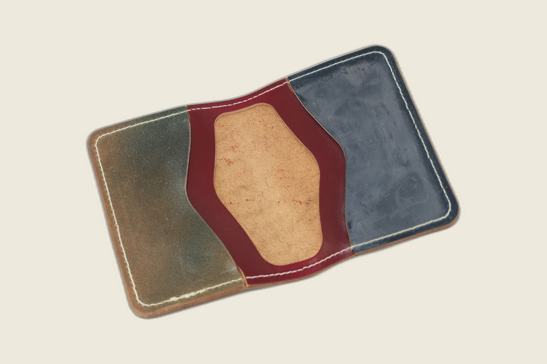 Warden bifold interior with olive, burgundy and navy Rocado shell panels around a tan suede well