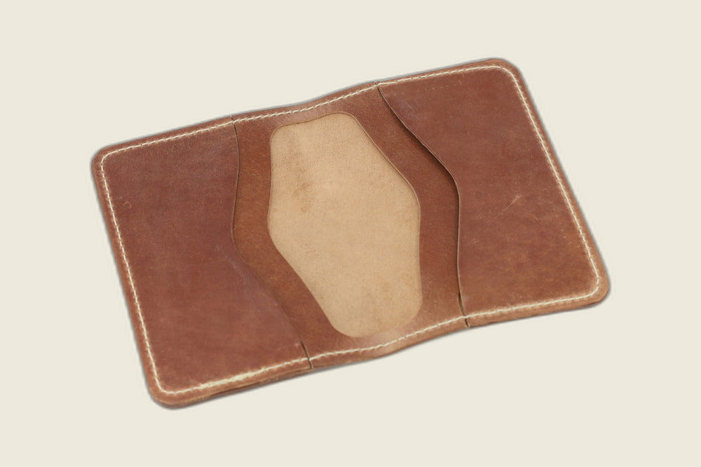 Warden bifold opened to marbled whiskey card pockets with a pale suede well