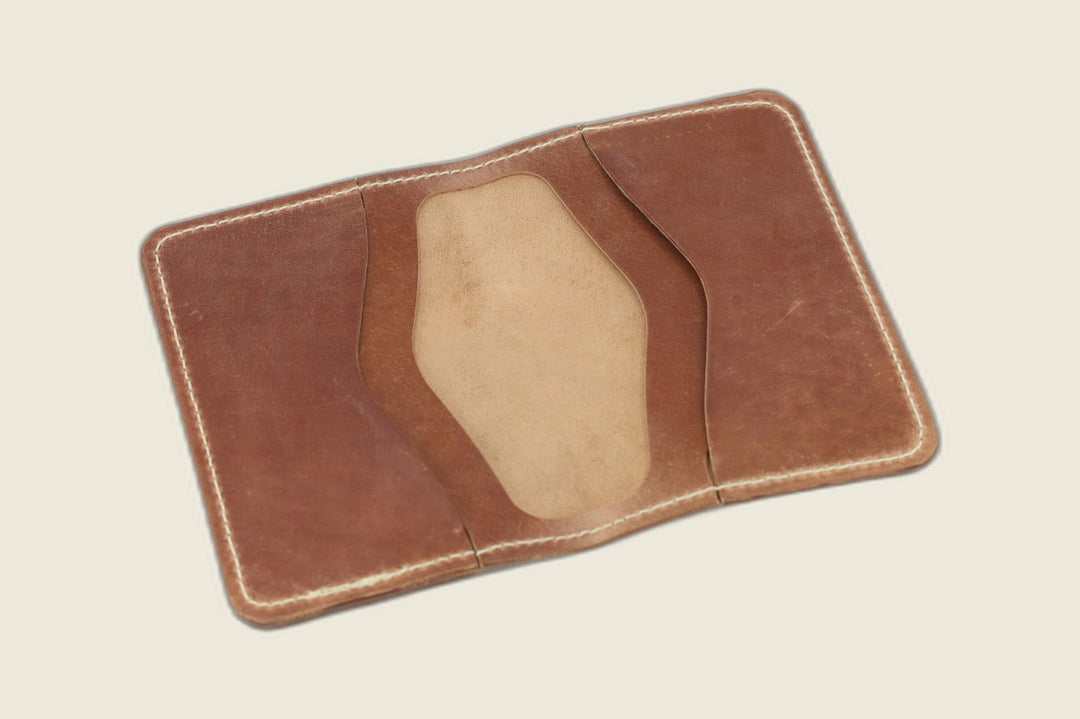 Warden bifold opened to marbled whiskey card pockets with a pale suede well