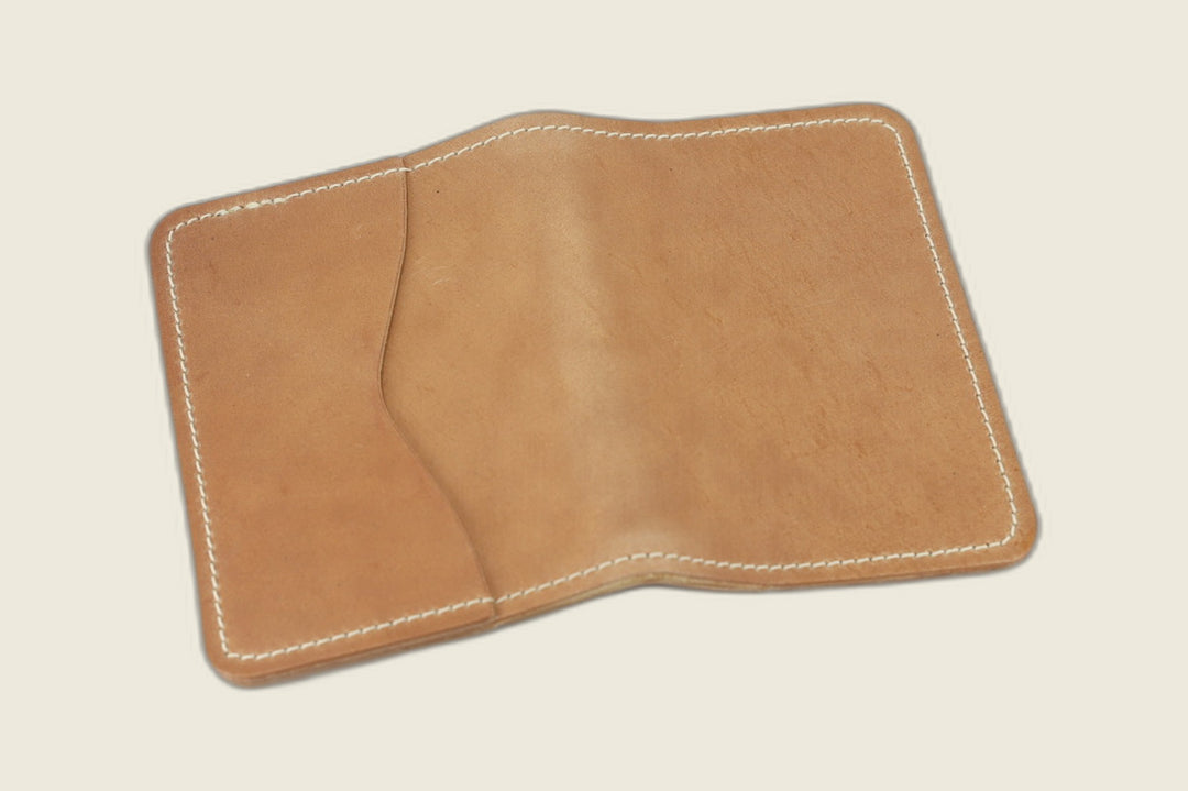 Warden bifold wallet in natural Cloe shell cordovan, light golden tan exterior, cream backdrop