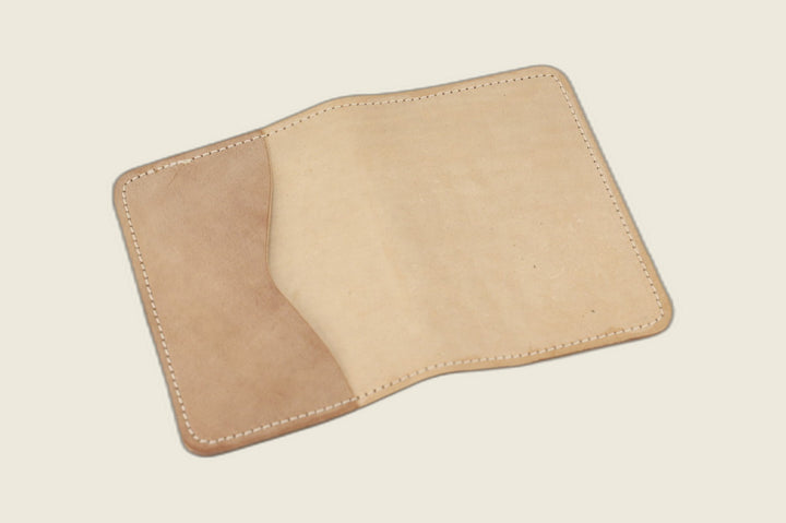 Warden bifold wallet in unglazed natural Cloe shell cordovan, cream-beige exterior, studio flat lay