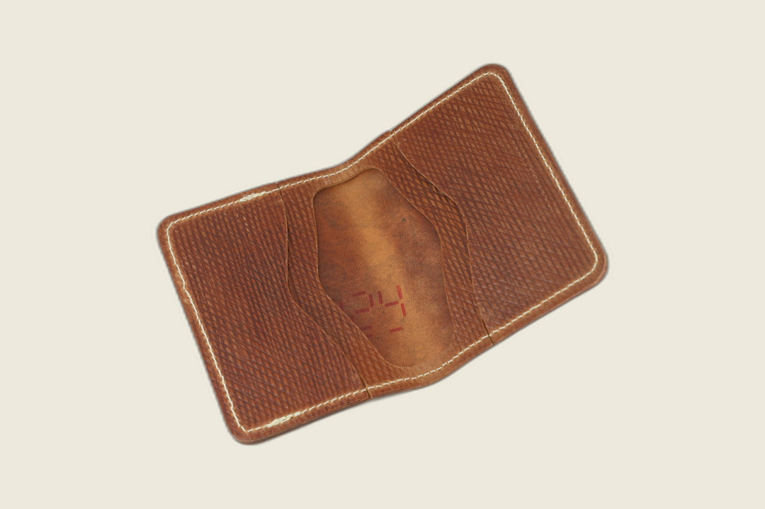 Warden wallet in light brown Russian grain shell cordovan opened flat to the stamped interior card recess