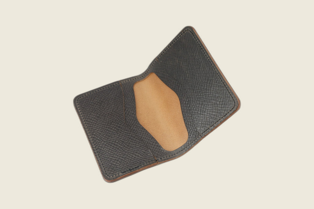 Warden bifold opened to gray Russian grain card pockets around a smooth tan well