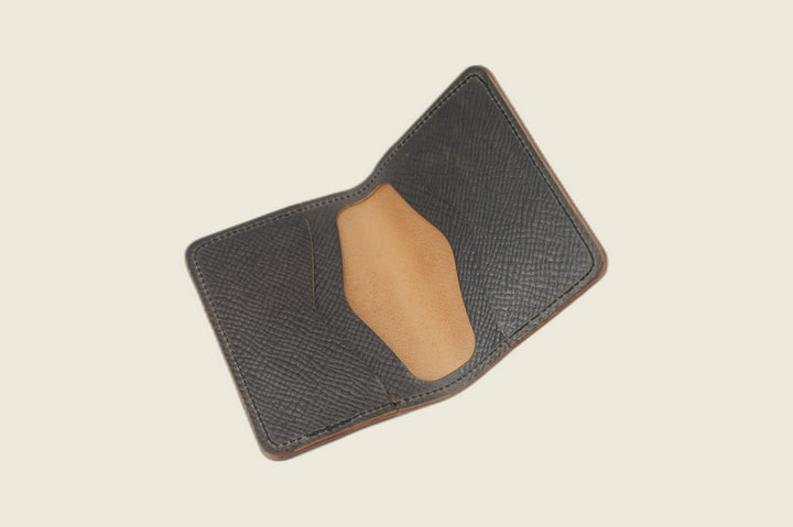 Warden bifold opened to gray Russian grain card pockets around a smooth tan well