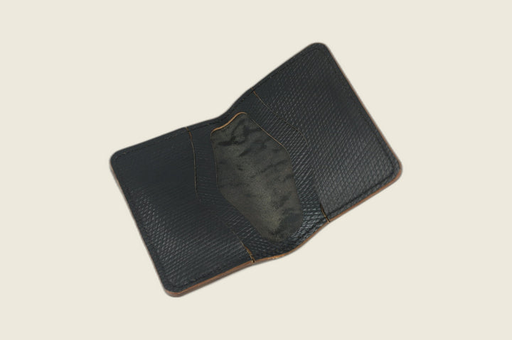 Warden wallet in black Russian grain shell cordovan opened to the interior card recess, tan edges visible