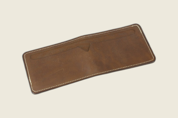Stronghold bifold wallet in dark olive-brown Maryam muschio horsebutt, open flat showing full-width notched pocket