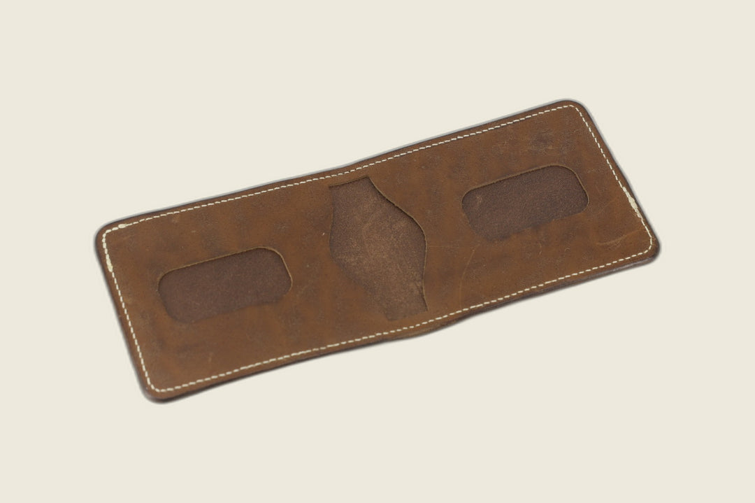Stronghold bifold in muschio horsebutt opened to two rounded card recesses and centre pocket cutout
