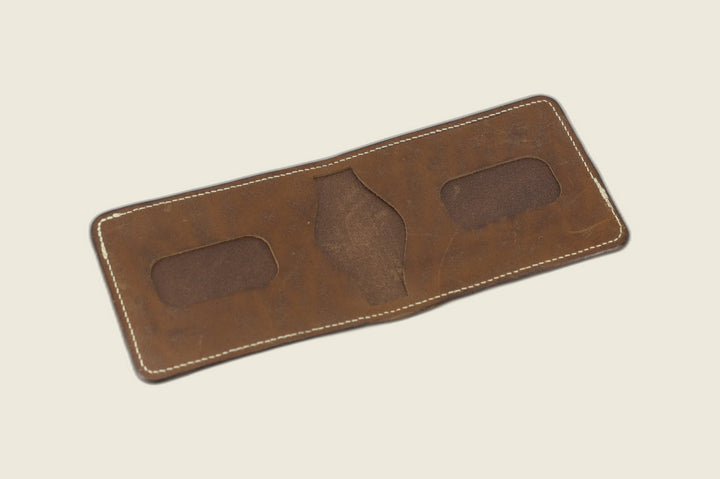 Stronghold bifold in muschio horsebutt opened to two rounded card recesses and centre pocket cutout