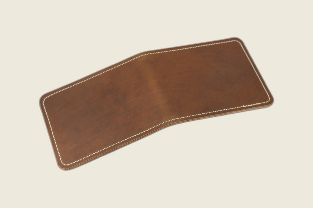 Stronghold bifold wallet in smooth light brown shell cordovan with cream stitching, open flat exterior view