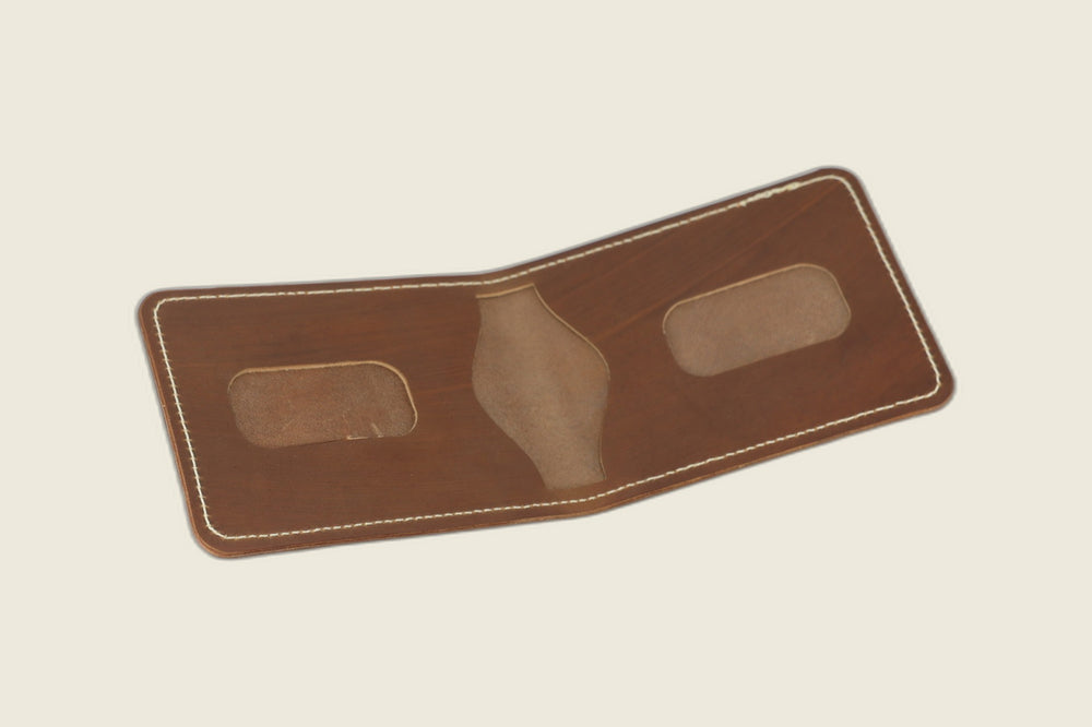 Stronghold bifold in light brown shell cordovan opened to rounded card recesses and centre pocket cutout