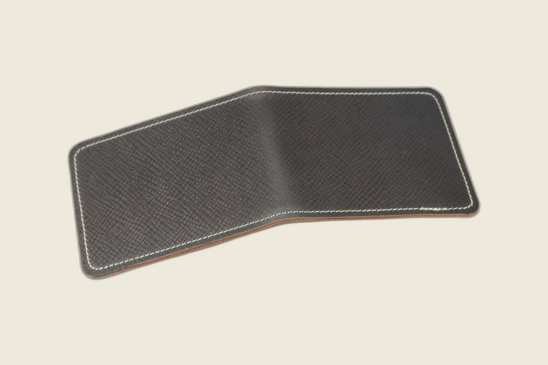 Stronghold bifold wallet in gray fine-grained shell cordovan, open flat showing the pebbled exterior