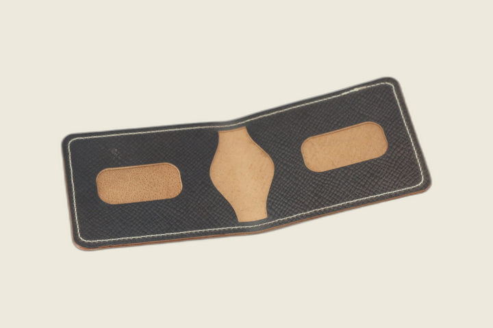 Stronghold bifold in gray shell cordovan opened to tan card recesses and centre pocket cutout