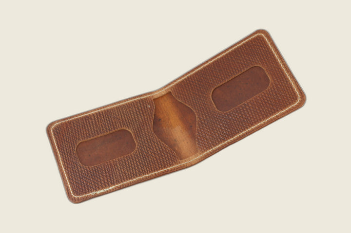 Stronghold bifold in light brown Russian grain shell cordovan opened to card recesses and centre cutout