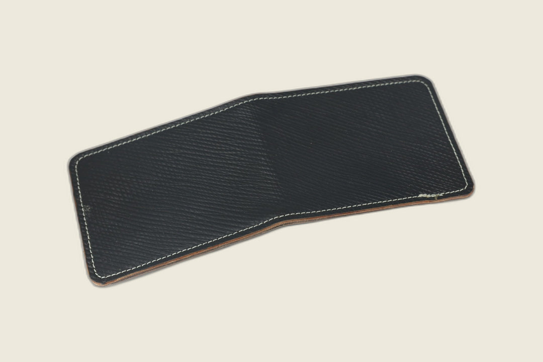 Stronghold bifold wallet in black Russian grain shell cordovan with cream stitching, open flat exterior view