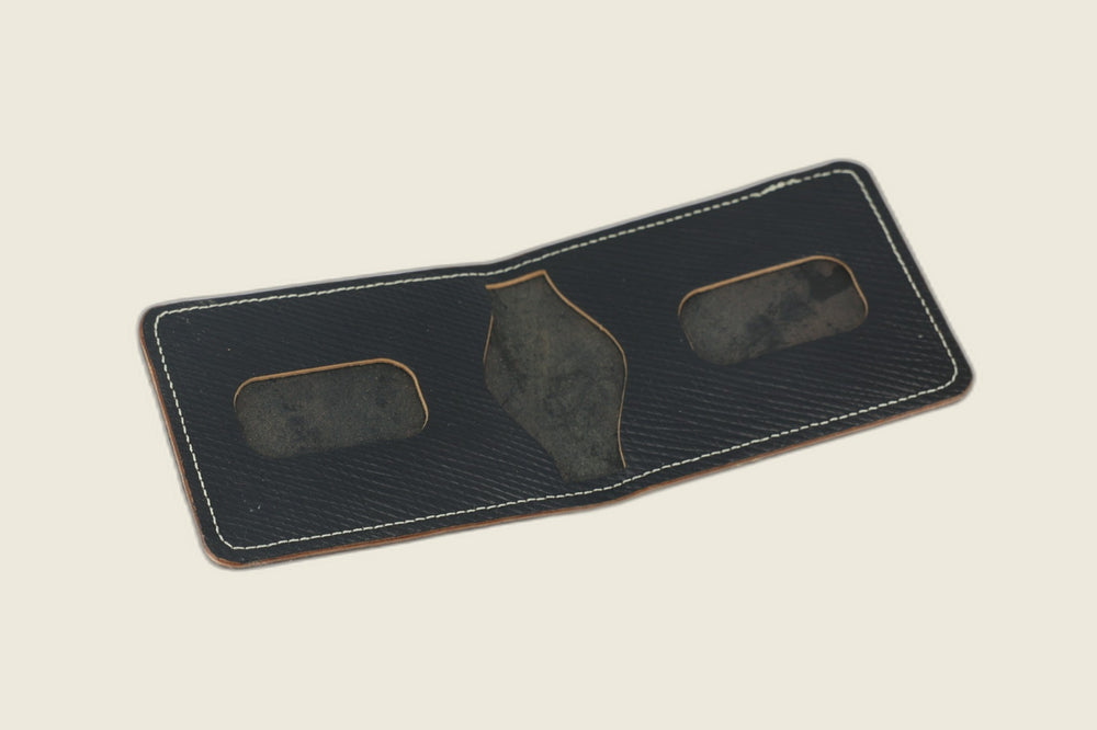 Stronghold bifold in black Russian grain shell cordovan opened to rounded card recesses and centre cutout