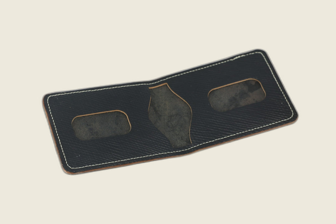 Stronghold bifold in black Russian grain shell cordovan opened to rounded card recesses and centre cutout