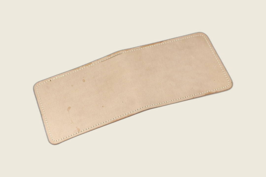 Stronghold bifold wallet in pale unglazed natural shell cordovan, open flat showing the matte exterior