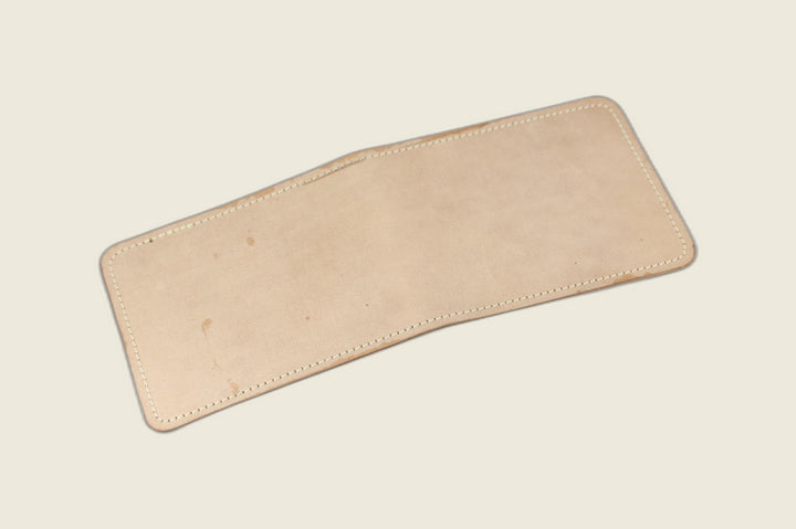 Stronghold bifold wallet in pale unglazed natural shell cordovan, open flat showing the matte exterior