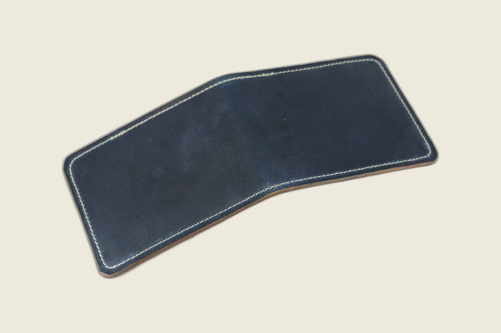 Stronghold bifold wallet in deep navy Rocado shell cordovan with cream stitching, open flat exterior