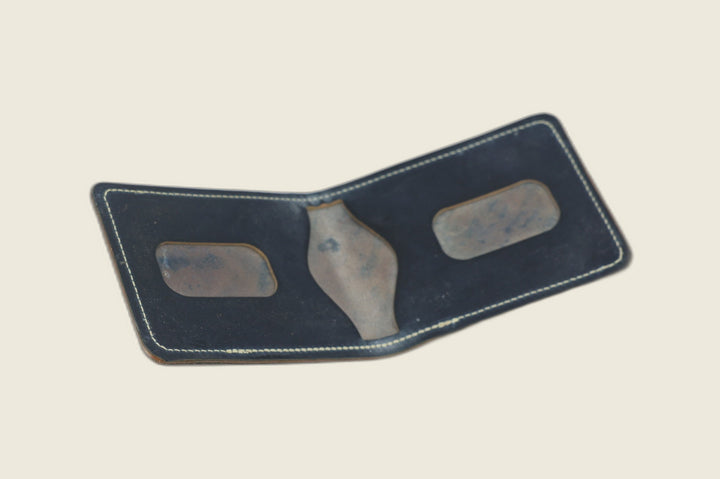 Stronghold bifold in navy shell cordovan opened to mottled card recesses and centre pocket cutout
