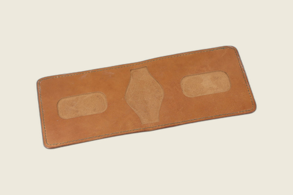 Stronghold bifold in tan 1940s calfskin opened to two rounded card recesses and centre cutout