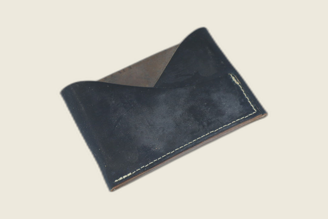 Sentinel front pocket wallet in matte navy Rocado shell cordovan with crossed diagonal pockets and cream stitching
