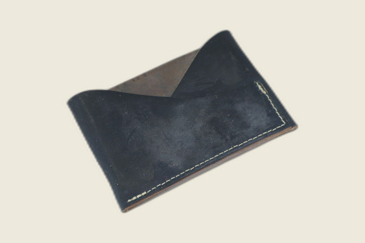 Sentinel front pocket wallet in matte navy Rocado shell cordovan with crossed diagonal pockets and cream stitching