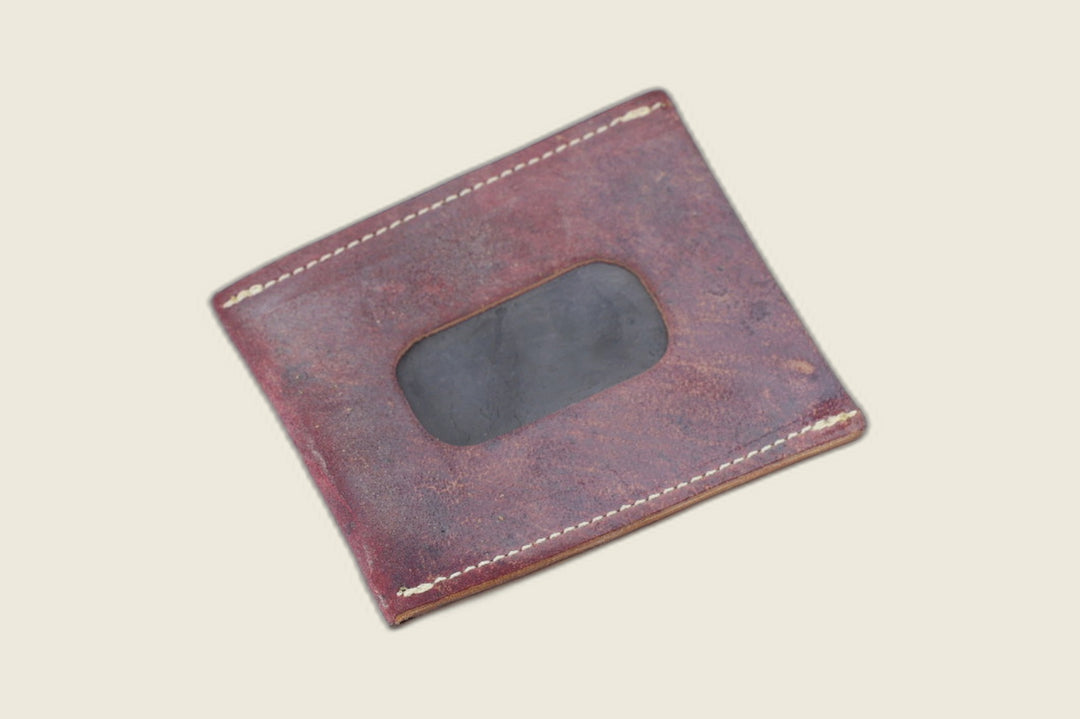ID window side of the marbled burgundy shell cordovan sleeve, dark window cutout amid mottled grain