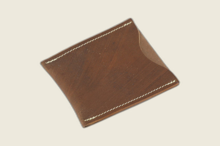 Safeguard sleeve front in light brown Toscana Italia shell cordovan, cream stitching and thumb scoop, angled on cream