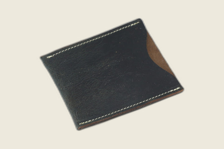 Safeguard sleeve front in navy Horween workshoe butt, deep pull-up sheen, cream stitching and thumb scoop