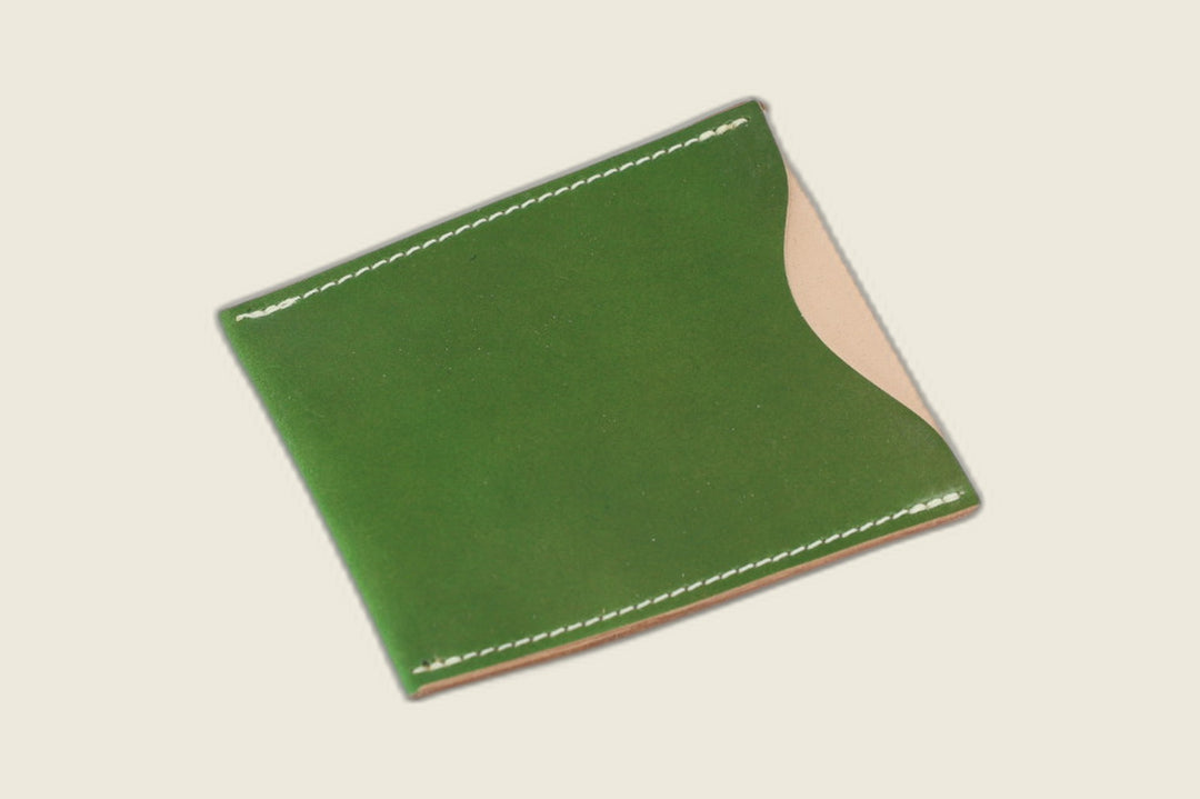Safeguard sleeve front in glossy candy apple green Shinki shell cordovan, natural shell visible at the thumb scoop