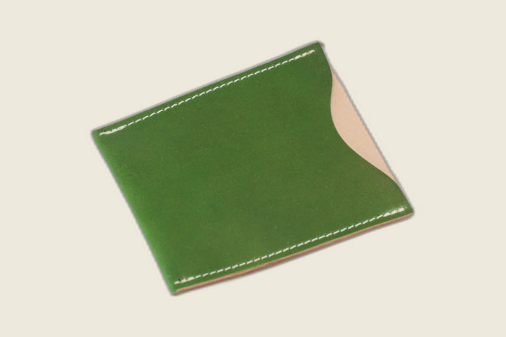 Safeguard sleeve front in glossy candy apple green Shinki shell cordovan, natural shell visible at the thumb scoop