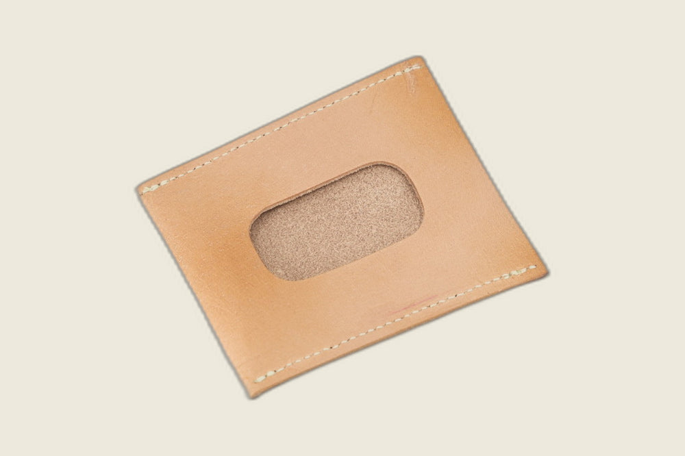 ID window side of the natural veg tan steerhide sleeve, rounded cutout showing a sanded suede backer