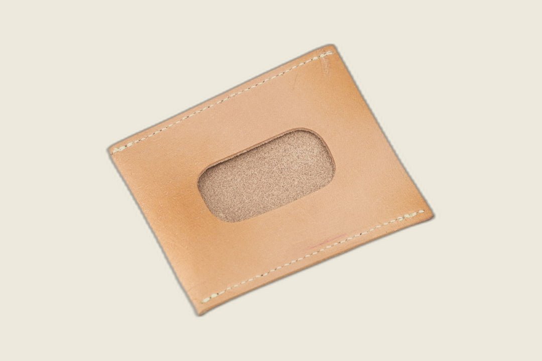 ID window side of the natural veg tan steerhide sleeve, rounded cutout showing a sanded suede backer