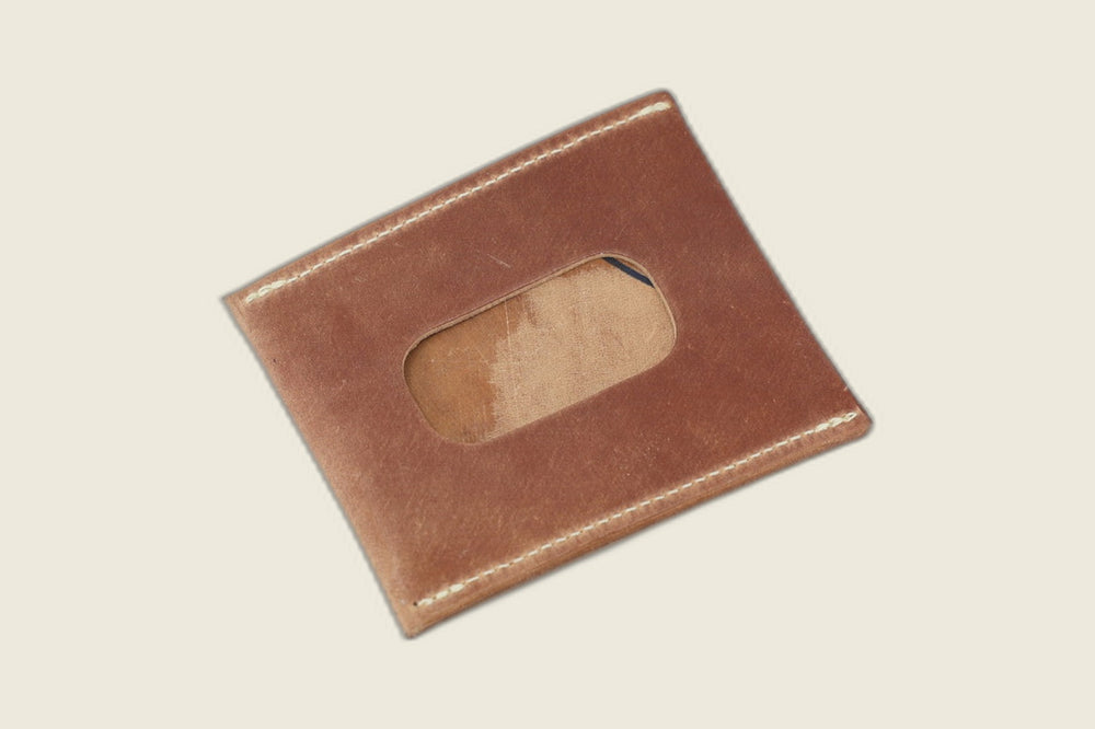 ID window side of the marbled light brown shell cordovan sleeve, streaked tan suede visible through the cutout