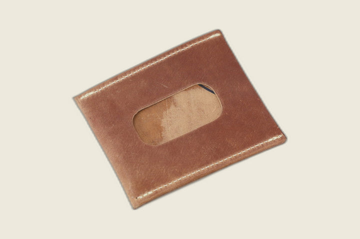ID window side of the marbled light brown shell cordovan sleeve, streaked tan suede visible through the cutout