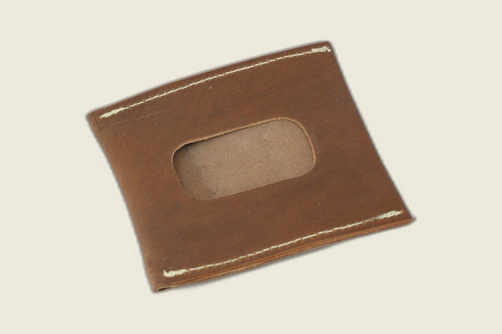 Back of the light brown shell cordovan sleeve with rounded ID window cutout over tan suede