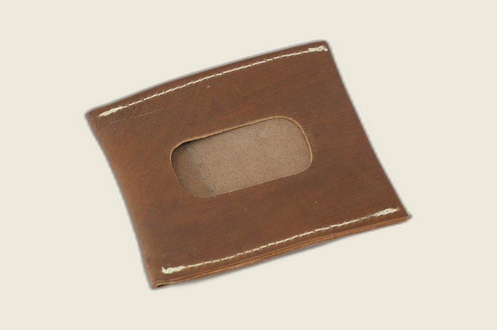 Back of the light brown shell cordovan sleeve with rounded ID window cutout over tan suede