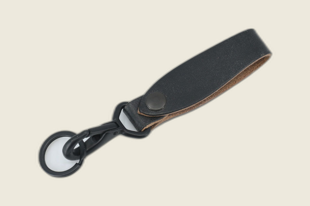 Lanyard in black J&FJ harness leather with black snap, swivel clasp and key ring, tan flesh side visible