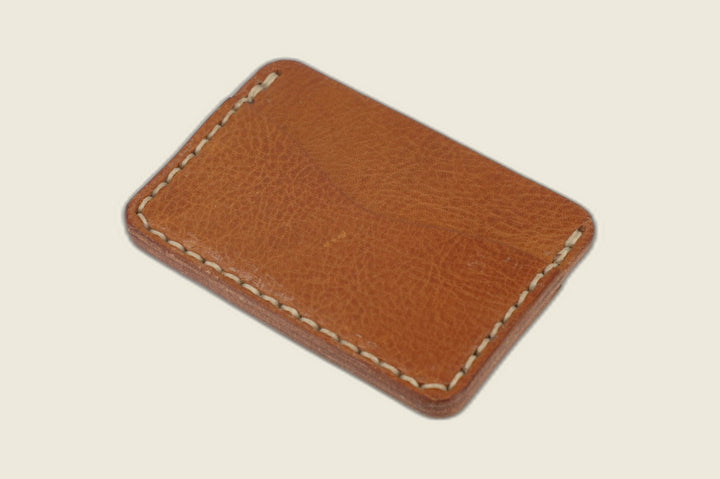 Second view of the Buckler Haas tan calfskin card holder showing paired curved slots and hand-stitched edges
