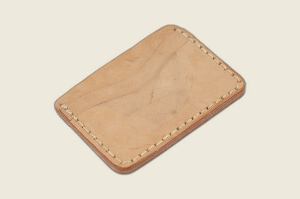 Reverse of the Buckler Maryam natural horsebutt card holder, single curved slot on pale natural leather