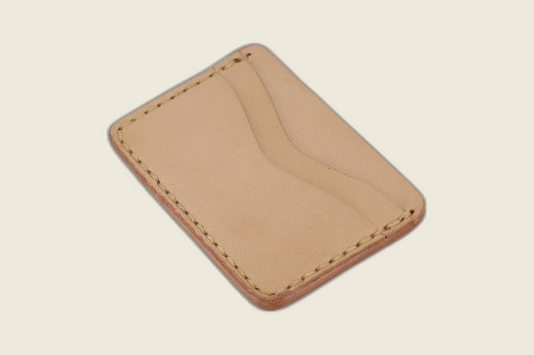 Flip side of the Buckler natural goat card holder showing one curved slot on pale veg-tan toned leather