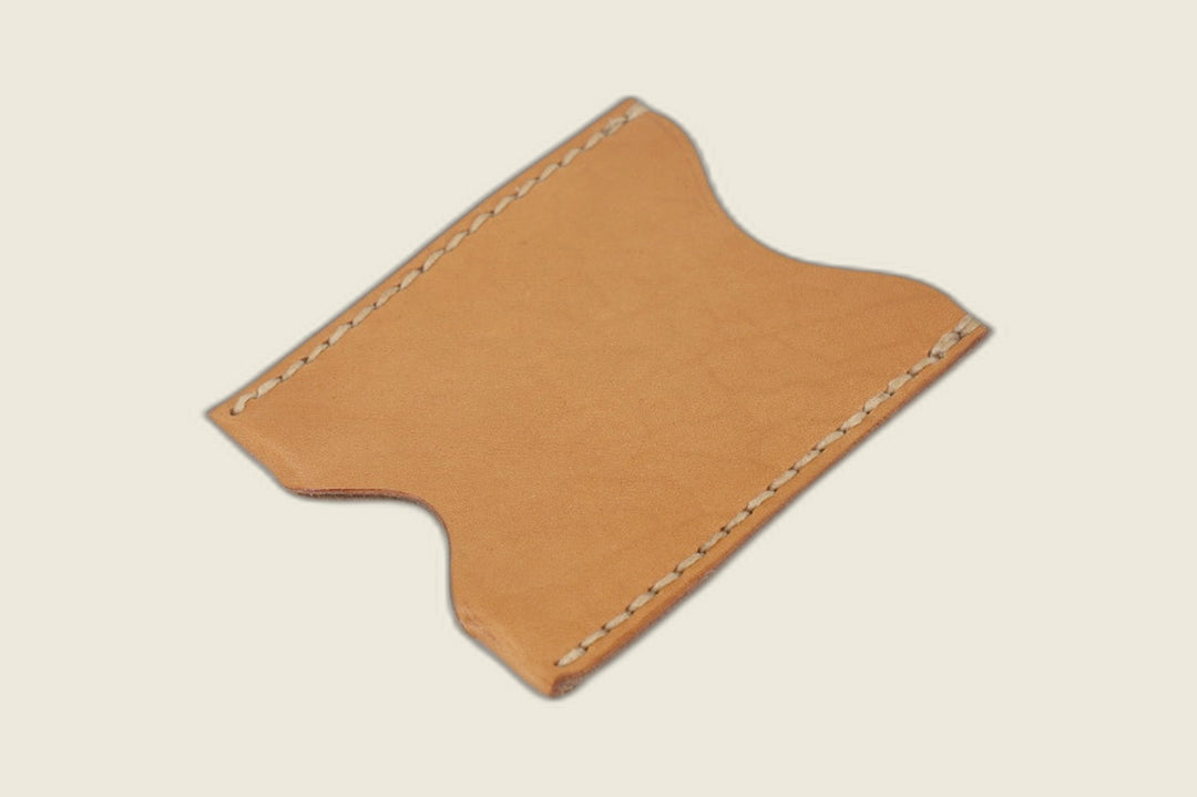 Safeguard card sleeve in Lo Stivale natural calfskin with scalloped thumb notches and cream saddle stitching