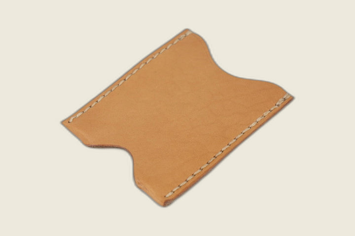 Safeguard card sleeve in Lo Stivale natural calfskin with scalloped thumb notches and cream saddle stitching